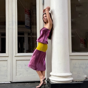 Detail view of purple metallic satin tube top and matching skirt with sleek sheen