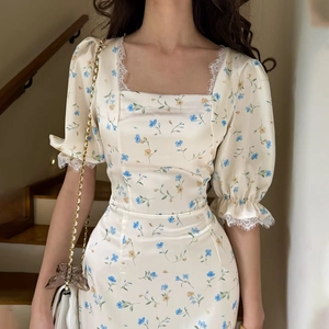Detail of square neckline with eyelash lace and floral print on puff sleeve dress