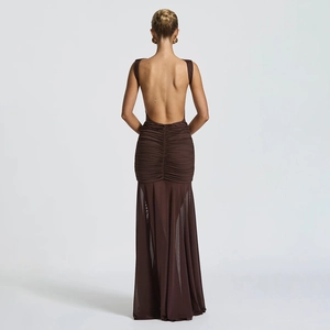 Detail of deep brown backless dress featuring elegant ruched pleats and sheer tulle hem