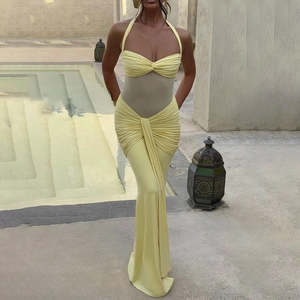 Detail of yellow halter neck dress featuring ruched fabric and sheer mesh waist panel