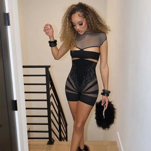 Detail of sexy black bodysuit featuring mesh cutouts and intricate totem patterns