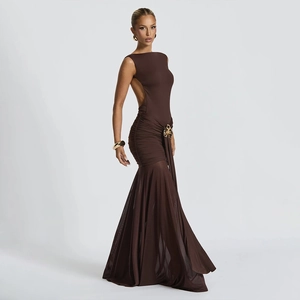 Detail of deep brown backless dress featuring a golden floral buckle and pleated textures
