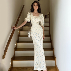 Close-up of square neckline with delicate lace trim on a floral satin midi dress