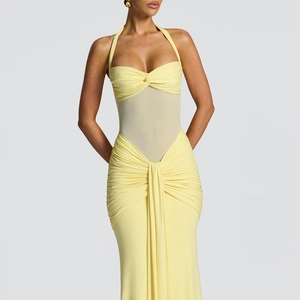 Detail of light yellow halter dress featuring sheer mesh patchwork and ruched fabric texture