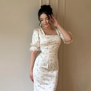 Close-up of French vintage square neck dress with lace bubble sleeves and floral print