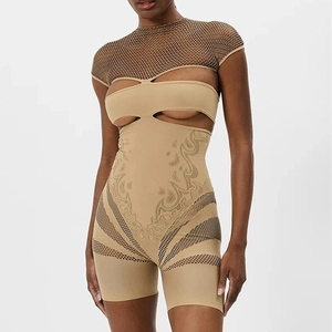 Detailed view of cutout bodysuit featuring mesh paneling and sheer textured fabric