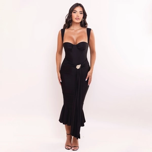 Close-up of slim-fit fishtail dress featuring a gold leaf buckle and pleated waist detail