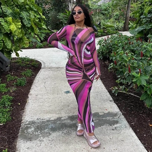 Close-up of sheer mesh maxi dress featuring vibrant abstract pink and purple spiral patterns