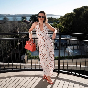 Detail of red polka dot halter maxi dress showing slim fit and elegant backless design