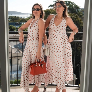 Detailed view of the halter V-neck polka dot dress with elegant backless pleat design