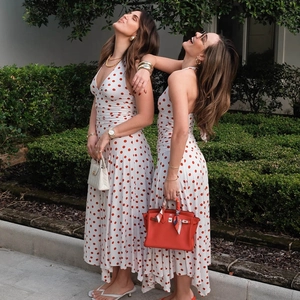 Detailed back view of a white and red polka dot halter neck dress with an open back design