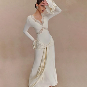 Close-up of elegant V-neckline with lace trim and ruched waist detail on a cream maxi dress