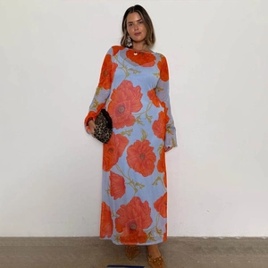 Detail of long sleeve mesh maxi dress featuring vibrant orange poppy prints and sheer fabric