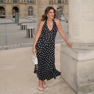 Detail of the plunging V-neckline and waist pleats on this elegant polka dot halter dress