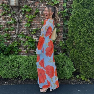 Detail view of long sleeve ankle-length dress with orange poppy print and bell cuffs