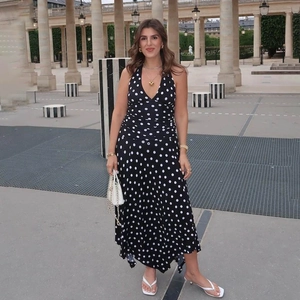 Detail of French style halter neck polka dot maxi dress with backless design and V-neckline