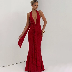 Detail of red halter deep V-neck dress with textured floral fabric and waist pleats