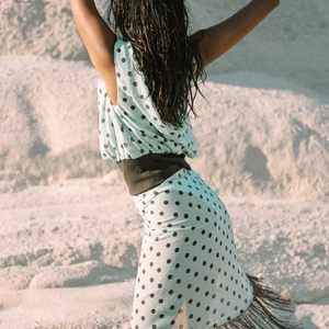 Light blue polka dot one-shoulder dress with fringe hem and wide waist belt back view