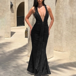 Detail of black halter neck dress featuring textured floral jacquard and deep V-neckline