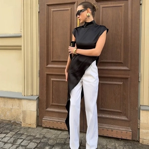 Top senza maniche in raso con collo alto e orlo asimmetrico e pantaloni bianchi