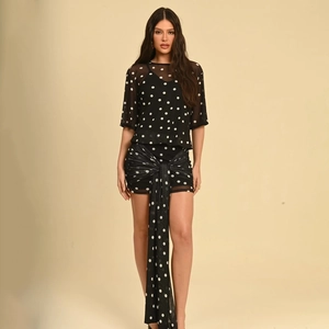 Detail of polka dot slim fit mini dress with semi-transparent mesh and long sash ribbons