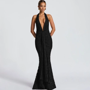 Detailed view of black halter neck dress with deep V-neckline and ruching texture