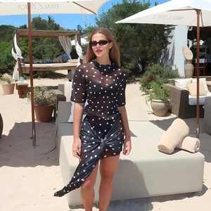 Detail of sheer polka dot mesh two-piece set with side knot and irregular skirt hem