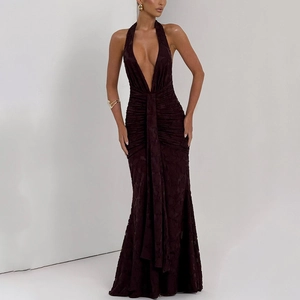 Detail of ruched texture and plunging V-neck on a slim fit brown backless maxi dress