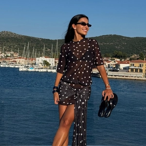 Detail of sheer black and white polka dot mesh beach cover-up set with tie-waist skirt