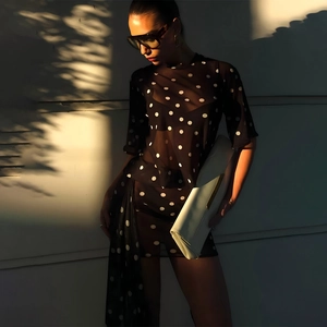 Close-up of sheer black polka dot fabric mesh and slim fit dress design details