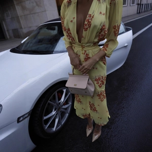 Deep V-neck floral chiffon dress detail with waist belt and long sleeves in bright yellow
