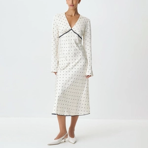 Detail of V-neck satin dress with black lace trim and delicate polka dot pattern
