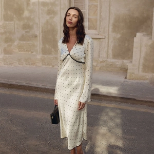 Elegant white satin midi dress with black polka dots and lace V-neck for chic women