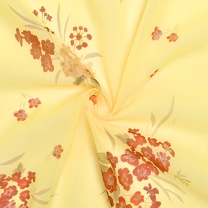 Detailed view of floral chiffon fabric with delicate red and pink flowers on light yellow