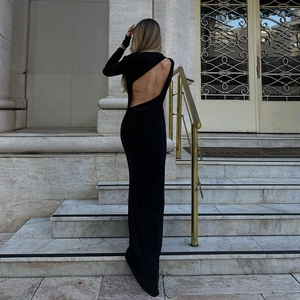Close-up of elegant black backless maxi dress showing the open back cut-out detail