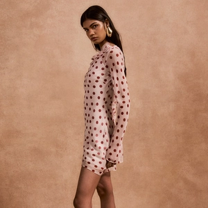 Detail of polka dot mini dress with 3D floral neckline and elegant long sleeves