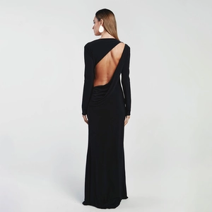 Close-up of the elegant deep backless cut and sleek knit fabric on this long black dress