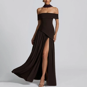 Detail of deep brown strapless evening dress featuring pleated slit and matching neck strap