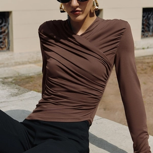 Slim fit brown long sleeve top featuring a chic V-neck cross design and elegant ruched details
