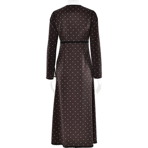 Detailed close-up of the vintage polka dot satin dress with elegant black lace trim
