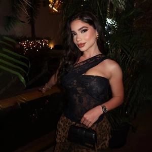 Detail of sexy lace off-shoulder top and leopard print mini skirt in night garden