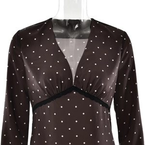 Detail of V-neckline with black lace trim on brown polka dot satin long sleeve dress