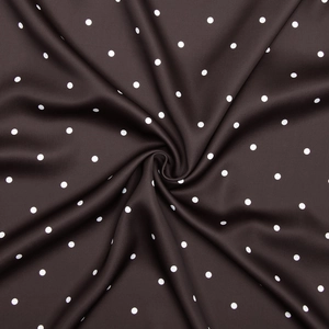 Close-up of brown satin fabric with white polka dots showing smooth texture and sheen