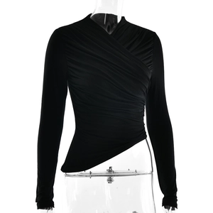 Detail of slim fit black long sleeve top with deep V-neck wrap design and ruched texture