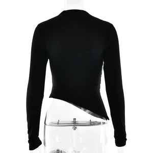 Detail of slim fit black long sleeve top featuring an asymmetric irregular cropped hemline