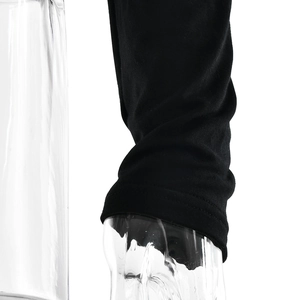 Detailed macro view of the double-stitched cuff on a black long-sleeved knitted top