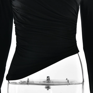 Detail of ruched side texture and asymmetrical hem on a black long sleeve slim T-shirt