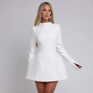 Detail of white mini dress with structured architectural cut and split sleeve cuffs