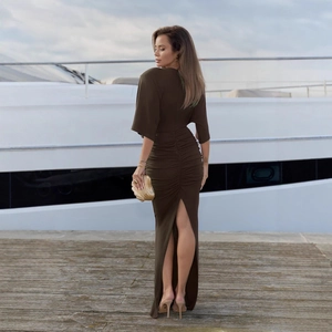 Detail of olive green dress featuring a back ruching design and a high leg slit