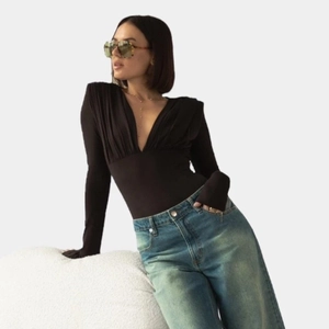 Slim fit black deep V-neck long sleeve bodysuit paired with vintage blue jeans